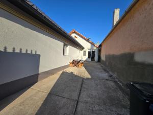 a bench sitting on a sidewalk next to a building at CASA de ACASA in Vintu De Jos