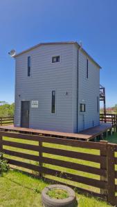 a large building on top of a wooden fence at PISÓN PDD in Punta Del Diablo