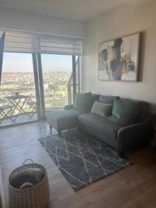 a living room with a couch and a large window at Exclusive Luxury Condo 2bd in Tijuana