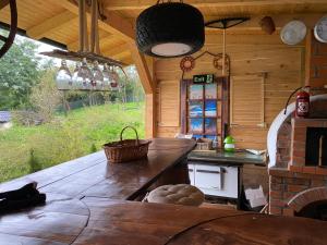 a kitchen with a large wooden table in a cabin at Casuta lu Carmen in Săbed