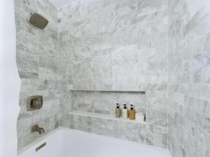 a bathroom with three bottles of alcohol sitting on a shelf at Luxurious Golf Course Hacienda At La Cita in Titusville +24 photos