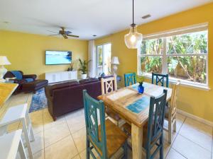 a dining room and living room with a table and chairs at Coastal Bliss Retreat - Beach Vibes & Rockets in Cocoa Beach