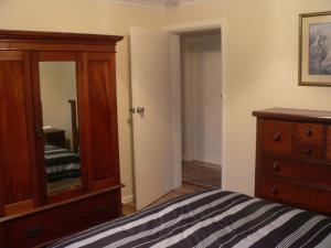 A bed or beds in a room at Bournda Retreat