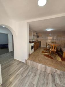 a kitchen and dining room with a table and a dining room at CASA de ACASA in Vintu De Jos