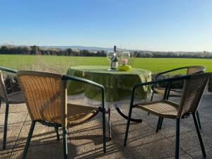 a table with two chairs and a bottle of wine at Villa Bellevue in Saint-Louis
