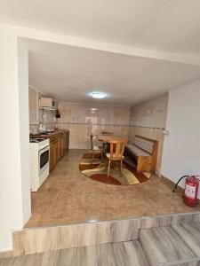a kitchen with a table and a dining room at CASA de ACASA in Vintu De Jos +10 photos