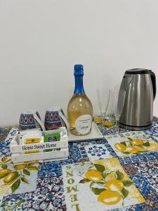 a table topped with a bottle of wine and glasses at CASA VACANZA IMPARO Ischia in Ischia Town