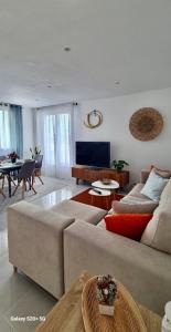 a living room with a couch and a table at Apartamento con terraza en Mogro Playa de Usil in Mogro