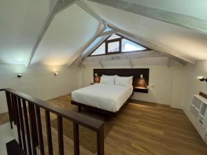 a bedroom with a bed in a attic at Caracoa Resort in General Luna