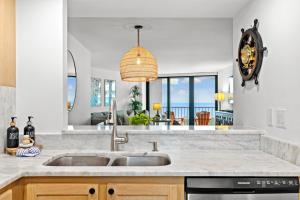 a kitchen with a sink and a view of the ocean at La Bella Vita on Marco - 1801 South Seas Tower 3 in Marco Island +38 photos