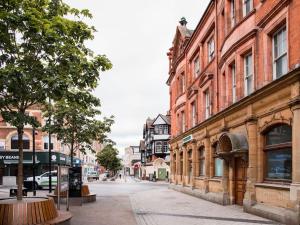 an empty street in a city with tall buildings at Castle Haven, Redhill in Redhill +13 photos