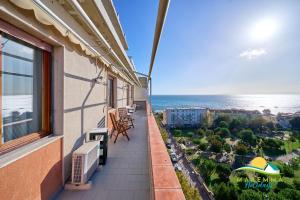 a balcony with chairs and a view of the ocean at Maremma Holidays Zot's Penthouse in Follonica