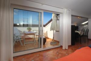 a sliding glass door leading to a patio with a table at Apartment Klepac in Punat