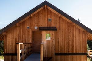 a large wooden building with a door at Chalet Cozy au Cœur de La Féclaz Séjour Authentique et Proche des Pistes in La Féclaz