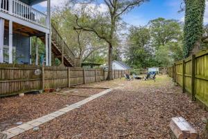 a backyard with a wooden fence and a fence at Half Off SALE! Downtown Home with King Bed FirePit Free Parking and Huge Back Yard Filming Allowed in Wilmington