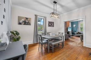 a dining room with a table and chairs at Half Off SALE! Downtown Home with King Bed FirePit Free Parking and Huge Back Yard Filming Allowed in Wilmington
