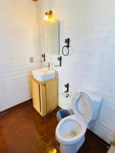 a bathroom with a toilet and a sink at Cabañas Ojo de Agua in Mazamitla +20 photos