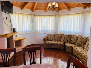 a living room with a couch and a table at Cabañas Ojo de Agua in Mazamitla
