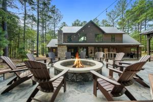 a patio with chairs and a fire pit in front of a house at Lazy Dog in Stephens Gap