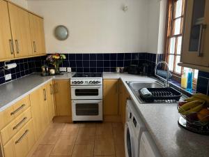 a kitchen with a stove and a sink at Robinson's Retreat - Cockermouth - Lake District in Cockermouth