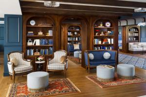 a living room with chairs and bookshelves at Nittany Lion Inn in State College