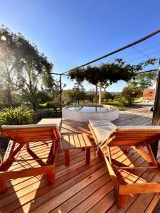 a wooden deck with two benches and a fountain at El Satélite in Córdoba
