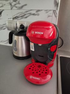 a red mixer sitting on top of a counter at Chez Elea - Au cœur d'Annecy & à deux pas du lac in Annecy