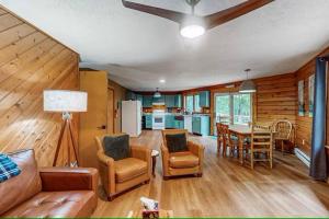 a living room with a couch and a table at Cozy Log Cabin Near Ski Area and Lake including Hot Tub in Swanton
