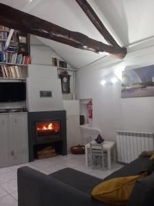 a living room with a couch and a fireplace at Casa do Paço com Jardim Privado - Centro de Terras de Bouro, Gerês in Terras de Bouro