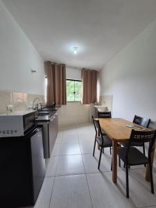 a kitchen and dining room with a table and chairs at Estúdio Charmoso no Centro de Apiaí in Apiaí