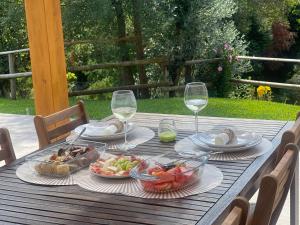a table with plates of food and glasses of wine at Casa da nascente douro in Paços de Gaiolo