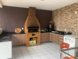 a kitchen with a brick oven in the middle at Carlos Nogueira in Parnaíba