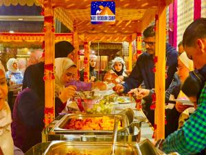 a group of people eating food at a buffet at NAEL BEDOUIN Camp in Wadi Rum