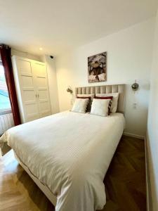 Ένα ή περισσότερα κρεβάτια σε δωμάτιο στο Appartement Cosy proche de Disney, Paris et Charles de Gaulle
