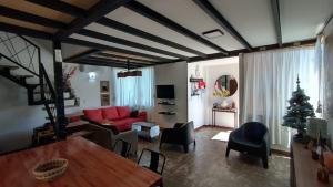 a living room with a red couch and a christmas tree at Cabaña Matilda in Lago Puelo