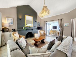 a living room with a couch and a fireplace at Strand Boat House in Cape Town