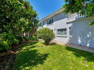 a house with a yard in front of it at Strand Boat House in Cape Town