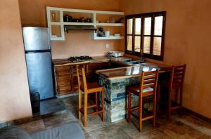 a kitchen with a stone counter and a refrigerator at Casa XhunaXhia in Zipolite