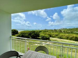 a balcony with a table and chairs and the ocean at Studio Saba cosy in Cul de Sac