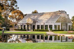 a house with a reflection in the water at Barkly Beachside Escape in Melbourne