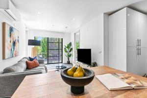 a living room with a table with pears on it at Barkly Beachside Escape in Melbourne