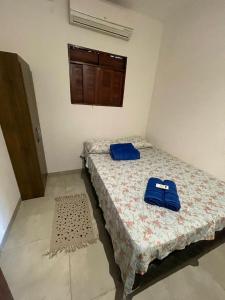 a bedroom with two beds with blue towels on it at Gostoso beach House pool in São Miguel do Gostoso