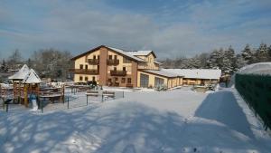 a large house in the snow with a yard at Sportpenzion Pohoda in Pilsen