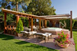 a backyard deck with a hot tub and a gazebo at Cerro Da Marina Hotel - Adults Only in Albufeira