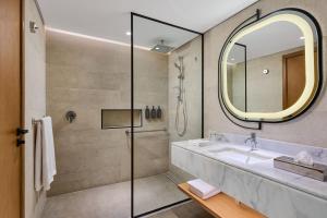a bathroom with a sink and a mirror at Sheraton Soma Bay Resort in Hurghada