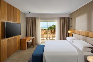 a hotel room with a bed and a flat screen tv at Sheraton Soma Bay Resort in Hurghada