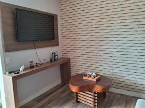 a room with a table in front of a wall at Casa de praia natureza in Torres