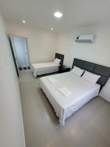 Postel nebo postele na pokoji v ubytování Duplex 3 suítes Ar wifi e vista total da orla