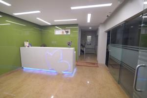 an office with a reception desk with a butterfly painted on it at Hotel Vijay in Madurai