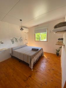 a bedroom with a bed and a window in it at Brisa del Sur Lofts in La Paloma